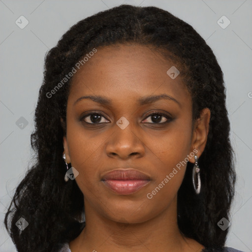 Joyful black young-adult female with long  black hair and brown eyes