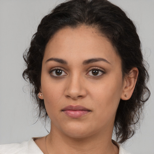 Joyful latino young-adult female with medium  brown hair and brown eyes