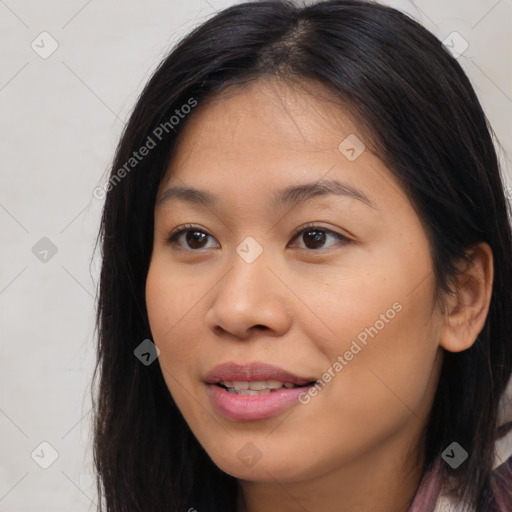 Joyful latino young-adult female with long  brown hair and brown eyes