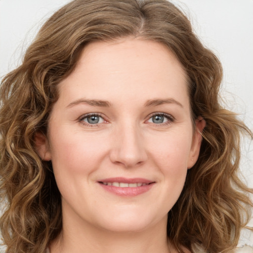 Joyful white young-adult female with long  brown hair and green eyes