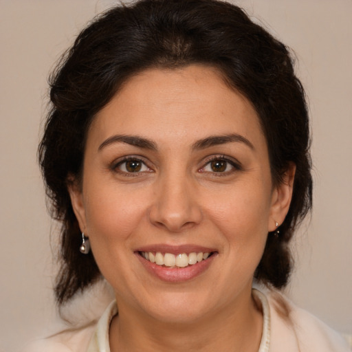 Joyful white adult female with medium  brown hair and brown eyes