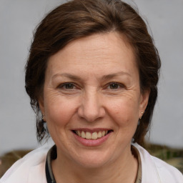 Joyful white adult female with medium  brown hair and brown eyes