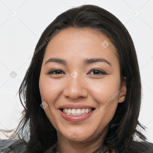 Joyful latino young-adult female with long  brown hair and brown eyes