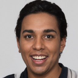 Joyful latino young-adult male with short  black hair and brown eyes