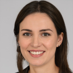 Joyful white young-adult female with medium  brown hair and brown eyes