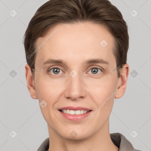 Joyful white young-adult female with short  brown hair and grey eyes