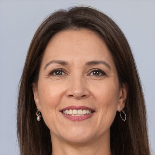 Joyful white adult female with long  brown hair and grey eyes