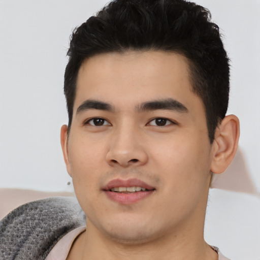 Joyful asian young-adult male with short  black hair and brown eyes