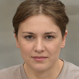 Joyful white young-adult female with short  brown hair and grey eyes