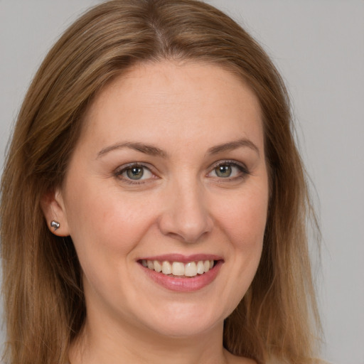 Joyful white young-adult female with long  brown hair and brown eyes