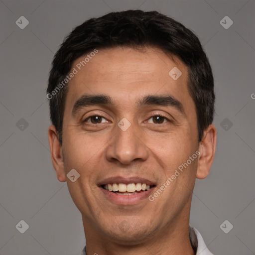 Joyful white adult male with short  black hair and brown eyes