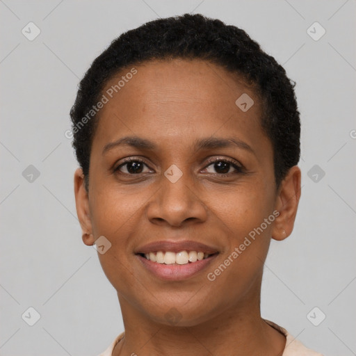 Joyful black young-adult female with short  black hair and brown eyes