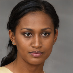 Joyful black young-adult female with medium  brown hair and brown eyes