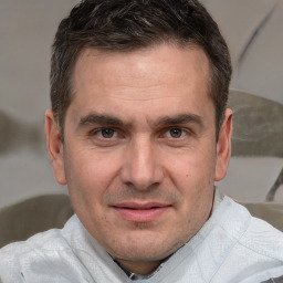 Joyful white adult male with short  brown hair and brown eyes