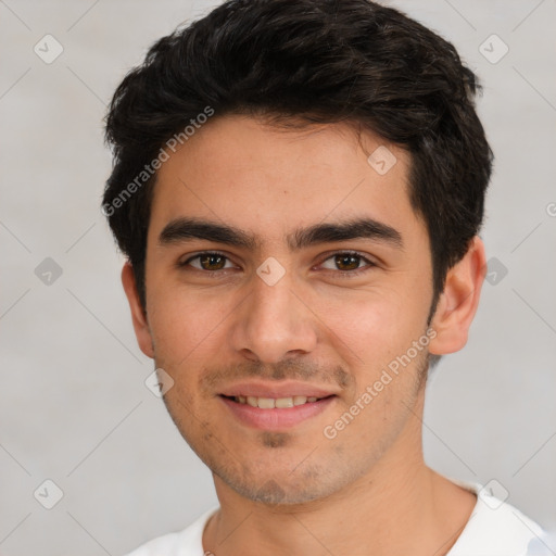 Joyful white young-adult male with short  black hair and brown eyes