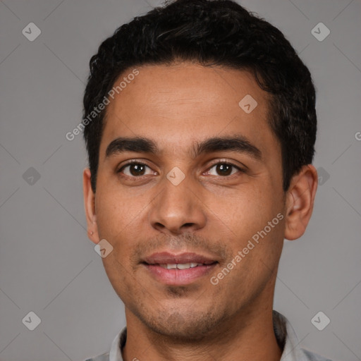 Joyful white young-adult male with short  black hair and brown eyes