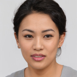 Joyful asian young-adult female with short  brown hair and brown eyes