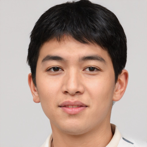 Joyful asian young-adult male with short  brown hair and brown eyes