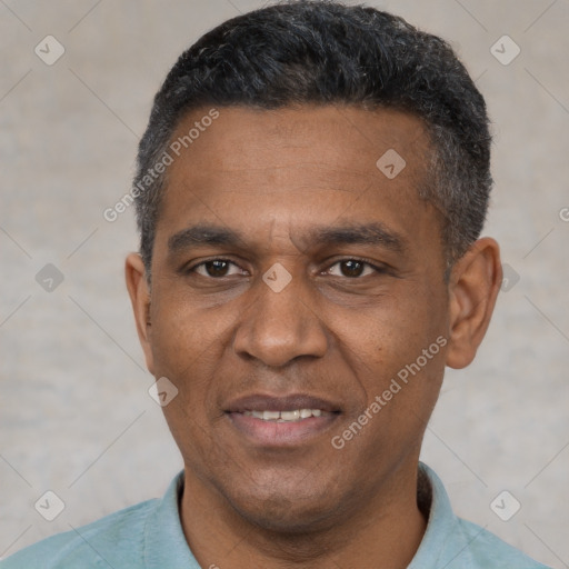 Joyful black adult male with short  black hair and brown eyes