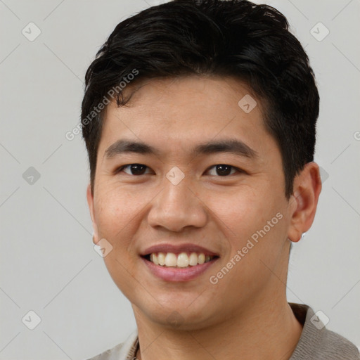 Joyful white young-adult male with short  black hair and brown eyes