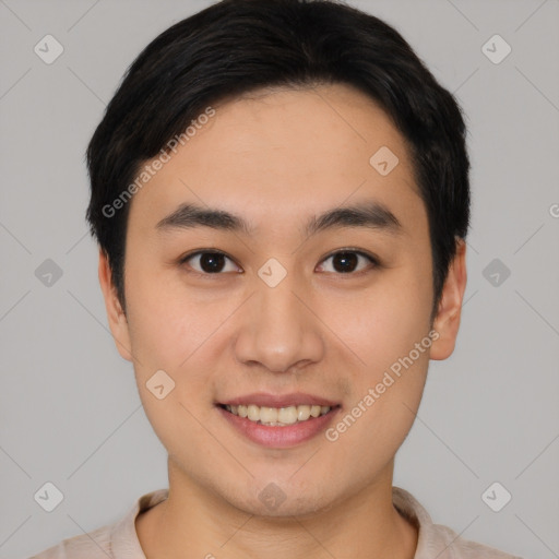 Joyful asian young-adult male with short  black hair and brown eyes