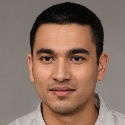 Joyful white young-adult male with short  black hair and brown eyes