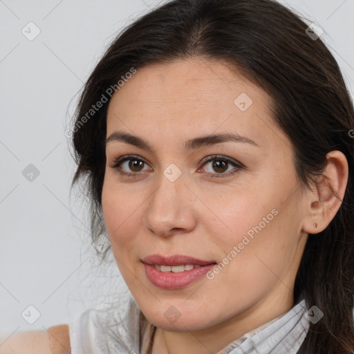 Joyful white adult female with medium  brown hair and brown eyes