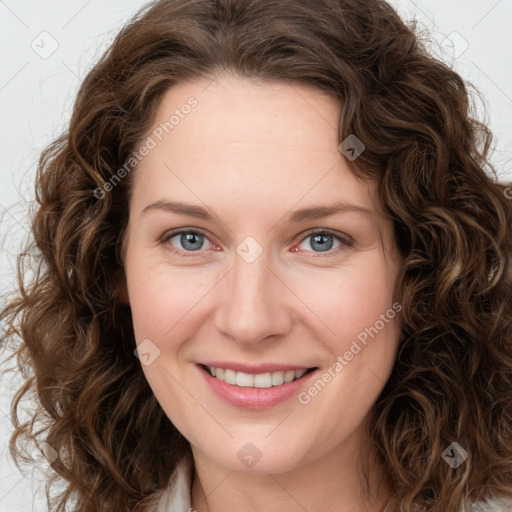 Joyful white young-adult female with long  brown hair and green eyes