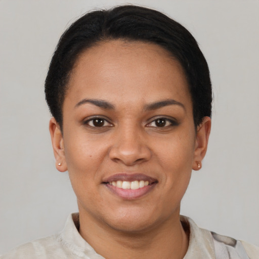 Joyful latino young-adult female with short  brown hair and brown eyes