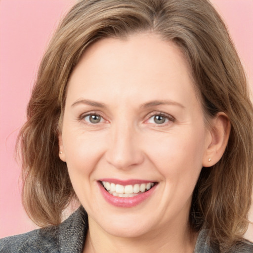 Joyful white adult female with medium  brown hair and grey eyes