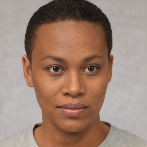Joyful black young-adult female with short  brown hair and brown eyes