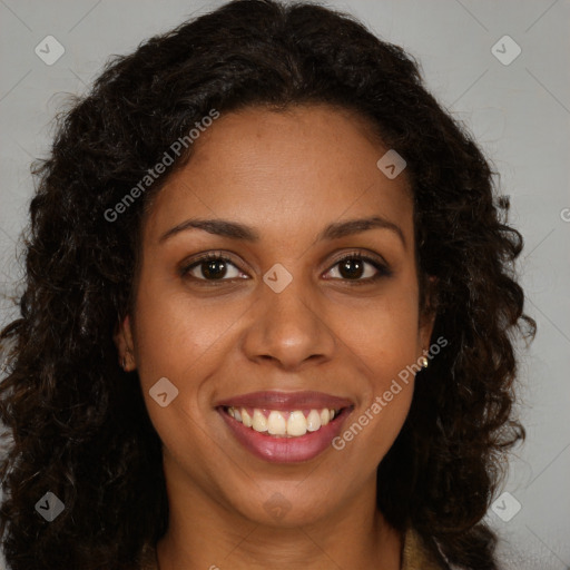 Joyful black young-adult female with long  brown hair and brown eyes