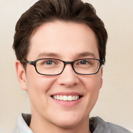 Joyful white young-adult male with short  brown hair and blue eyes