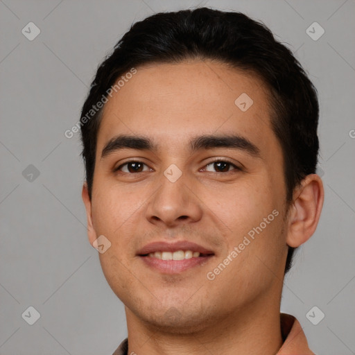 Joyful white young-adult male with short  black hair and brown eyes