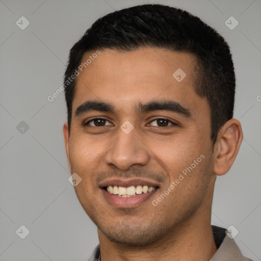 Joyful latino young-adult male with short  black hair and brown eyes