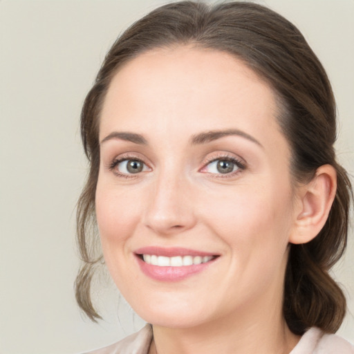 Joyful white young-adult female with medium  brown hair and blue eyes