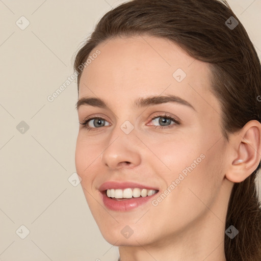 Joyful white young-adult female with medium  brown hair and green eyes