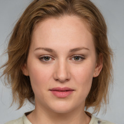 Joyful white young-adult female with medium  brown hair and blue eyes