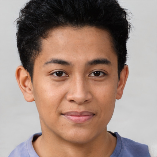 Joyful latino young-adult male with short  brown hair and brown eyes