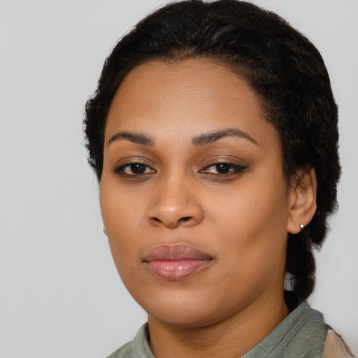 Joyful latino young-adult female with short  brown hair and brown eyes
