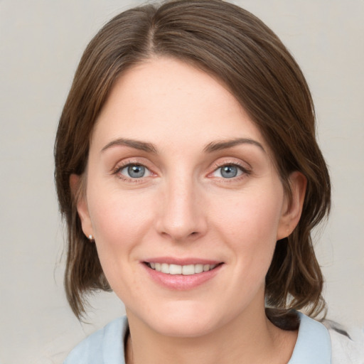 Joyful white young-adult female with medium  brown hair and blue eyes