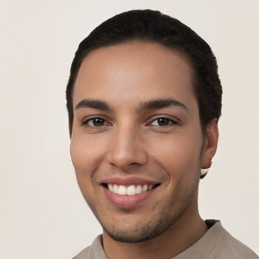 Joyful white young-adult male with short  black hair and brown eyes