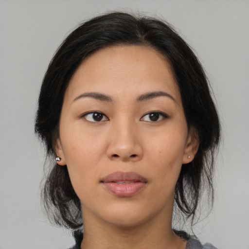 Joyful asian young-adult female with medium  brown hair and brown eyes