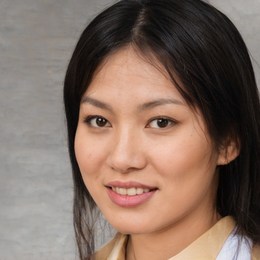 Joyful asian young-adult female with medium  brown hair and brown eyes