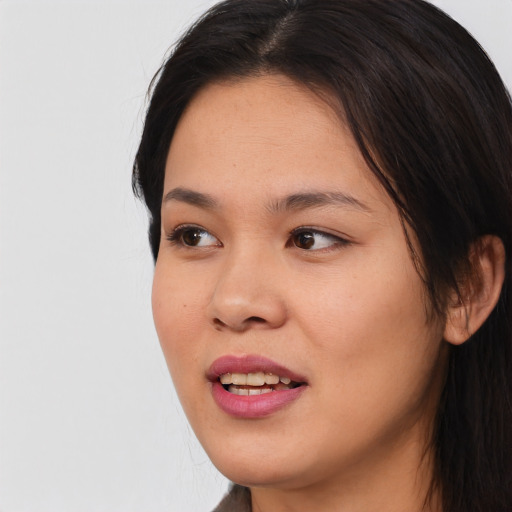 Joyful asian young-adult female with long  brown hair and brown eyes