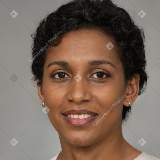 Joyful black adult female with short  brown hair and brown eyes