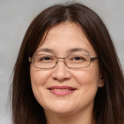 Joyful white adult female with medium  brown hair and brown eyes