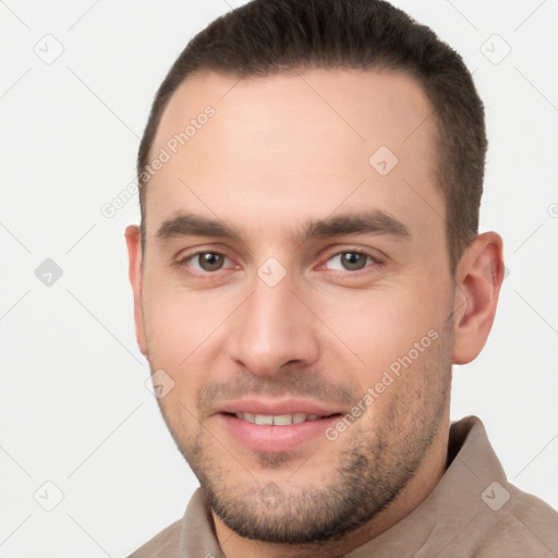 Joyful white young-adult male with short  brown hair and brown eyes