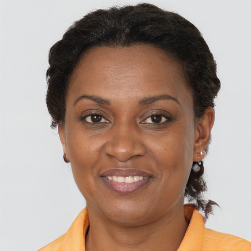 Joyful black adult female with short  brown hair and brown eyes