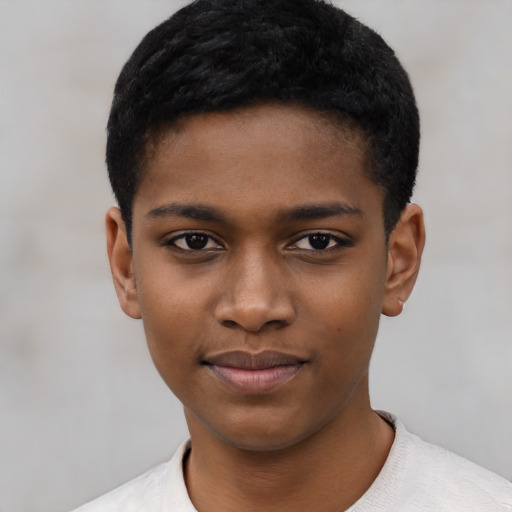 Joyful black child male with short  black hair and brown eyes